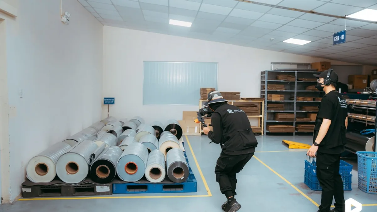 Workers from Nam Viet Group operate printing machines in the factory.