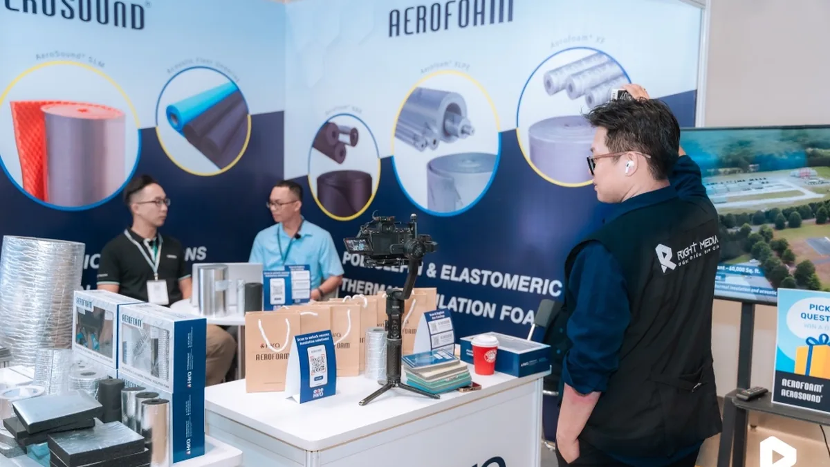The Right Media team prepares equipment at the exhibition area.