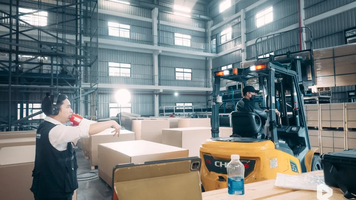 Filming a forklift transporting goods inside the Fletcher factory.