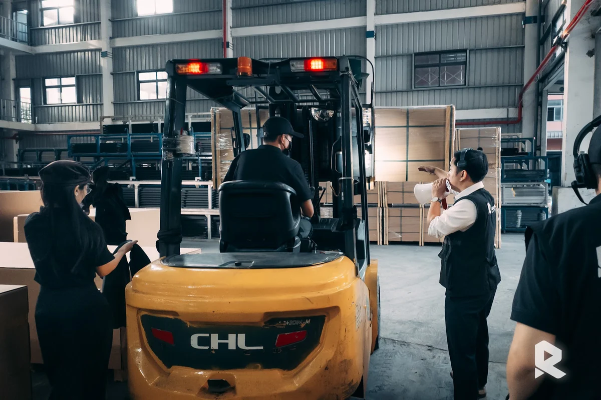 A scene of a forklift transporting goods in a testimonial video for the high-end aluminum door industry.