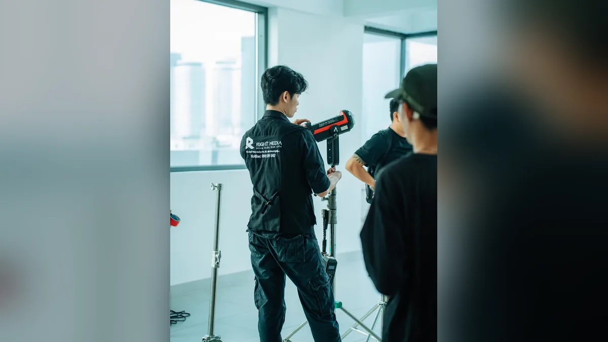 The Right Media team prepares equipment for the testimonial shoot at the Golden Lotus Construction office.