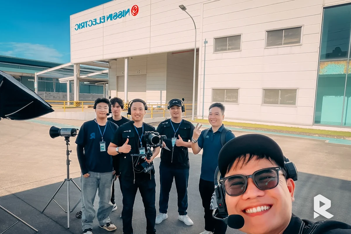 The production team prepares equipment for the second day of filming at Nissin Electric.