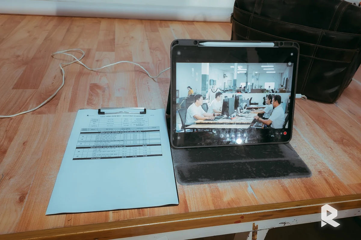 Reviewing on-site footage from a textile industry testimonial video project.