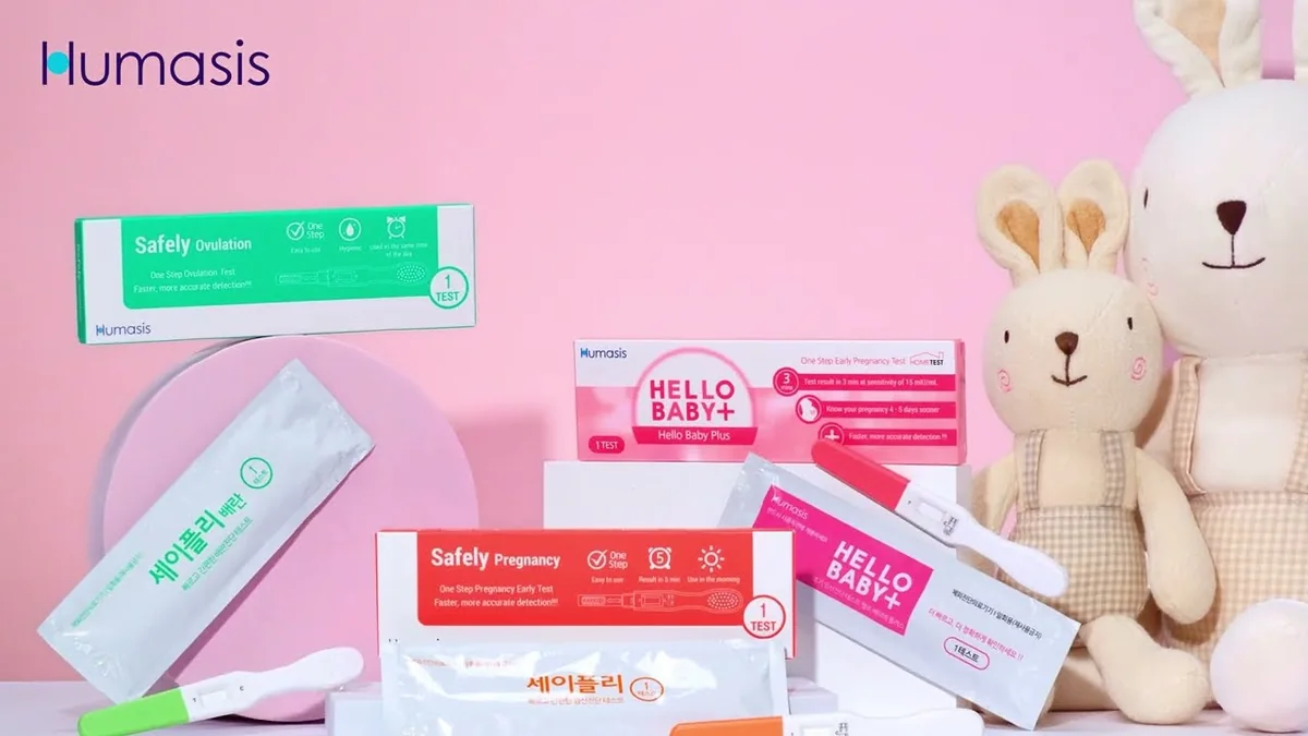 The packaging of the Hello Baby Plus pregnancy test from HUMASIS is next to a teddy bear.
