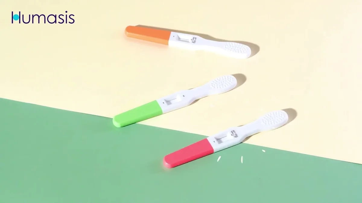 HUMASIS pregnancy test product video: colorful test strips on a pastel background.